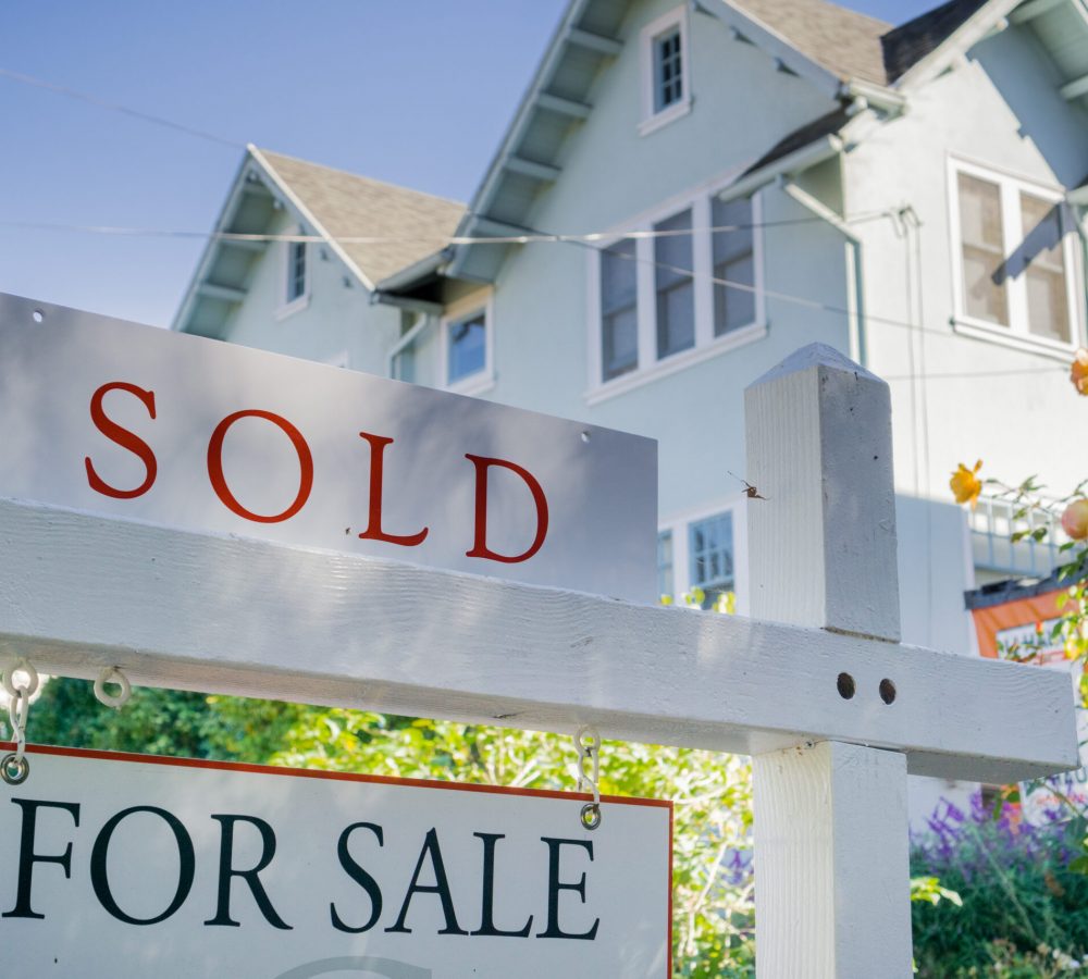 Sold sign in front of a house in a residential neighborhood, California